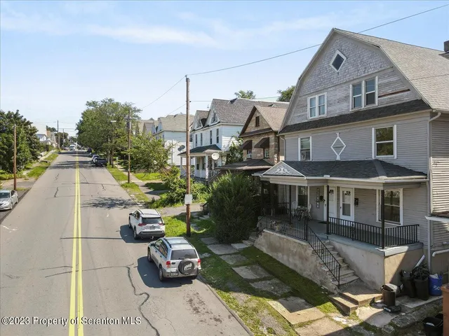 a aerial view of a house with sitting area and furniture
