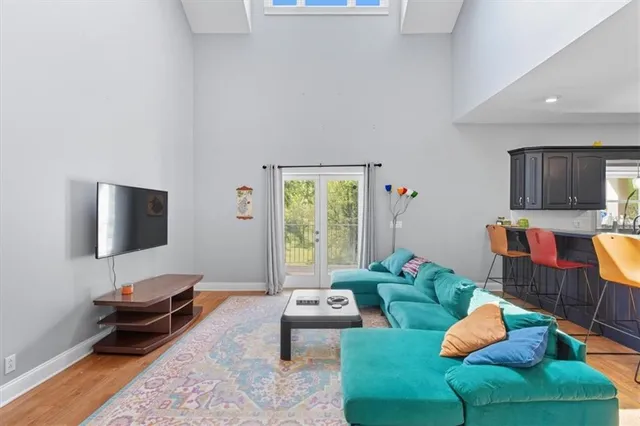 a living room with furniture and a view of kitchen