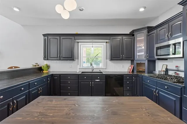a kitchen with wooden cabinets and center island