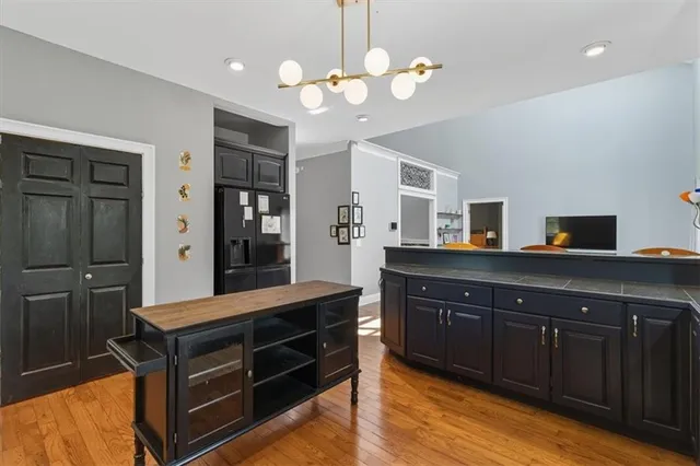 a kitchen with kitchen island granite countertop wooden cabinets and a sink