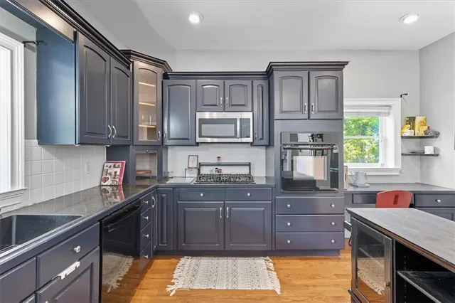 a view of a dining room with furniture a chandelier and wooden floor