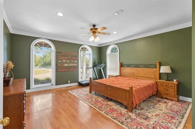 a spacious bathroom with sink a mirror a bathtub and next to a window
