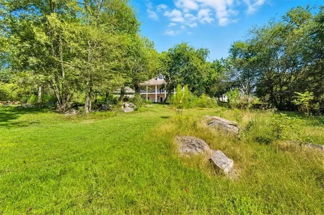 an aerial view of a house with a yard and garden