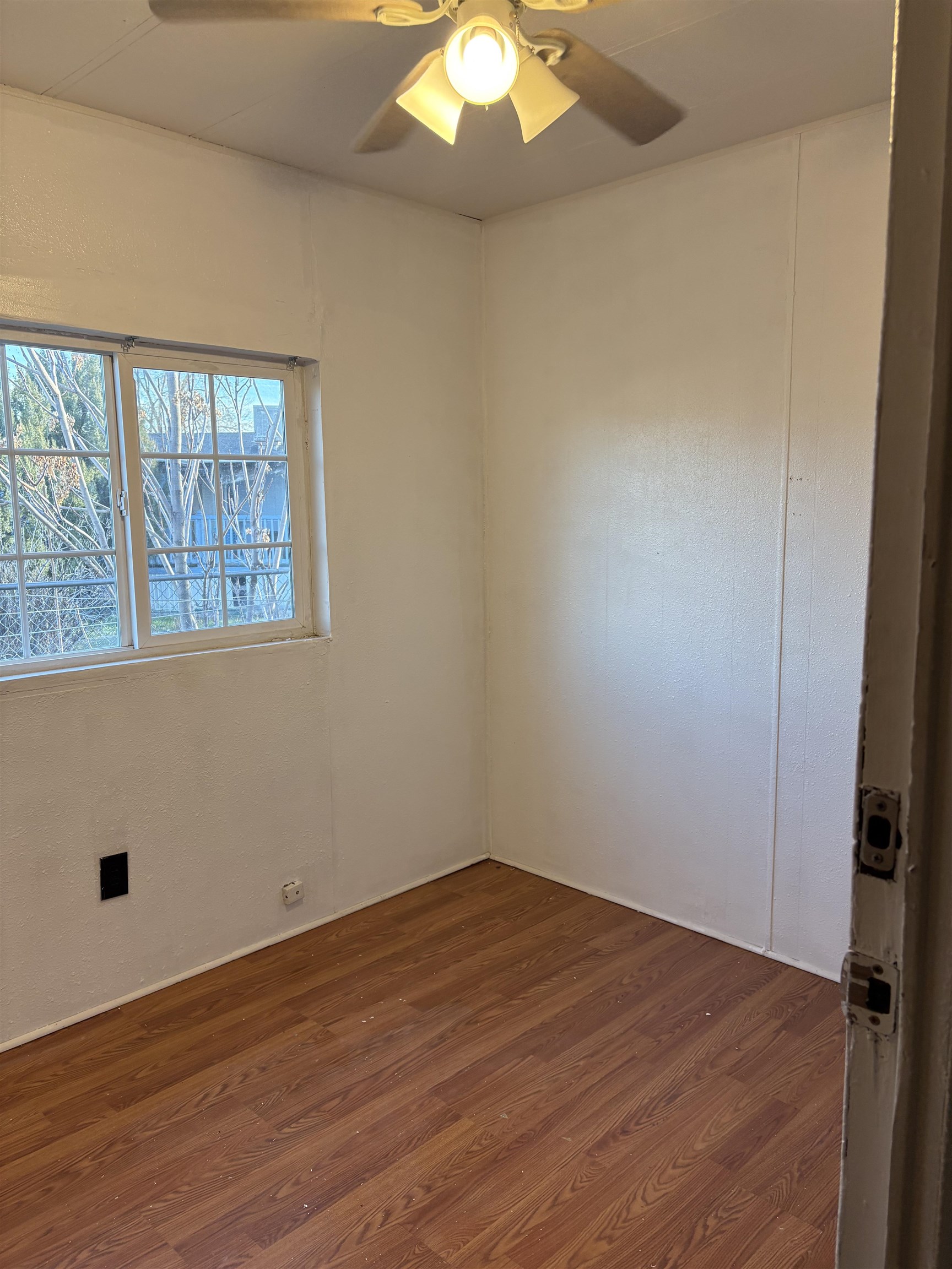 532 Centennial Road Grand Junction, CO 81504 - Photo 14 of 18 an empty room with wooden floor and windows