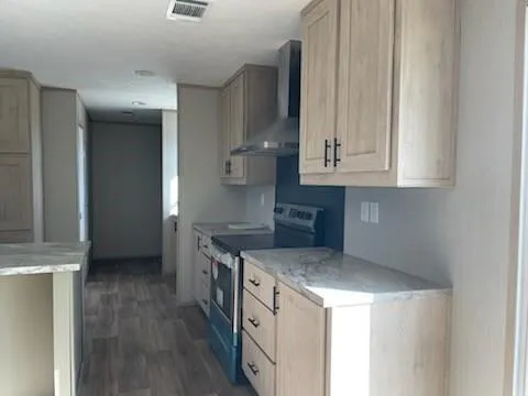 a kitchen with stainless steel appliances granite countertop a stove and a refrigerator
