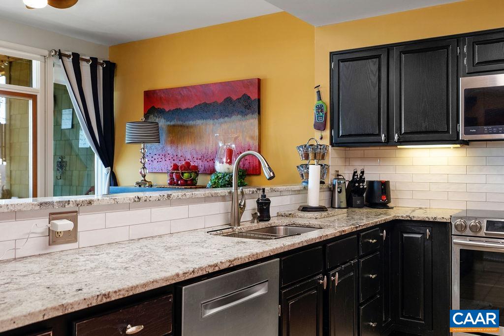 1707 High Ridge Wintergreen, VA 22967 - Photo 11 of 27 a kitchen with stainless steel appliances granite countertop a sink and a microwave