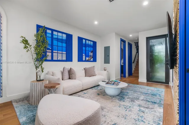 a living room with furniture and a potted plant