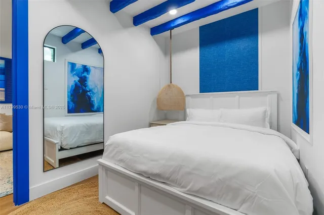 a view of a hallway with wooden floor and entryway