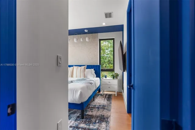 a bed sitting in a bedroom next to a window