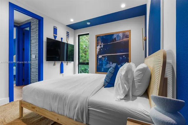 a bedroom with a bed and a television