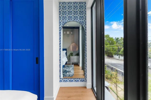 a bed sitting in a bedroom next to a window