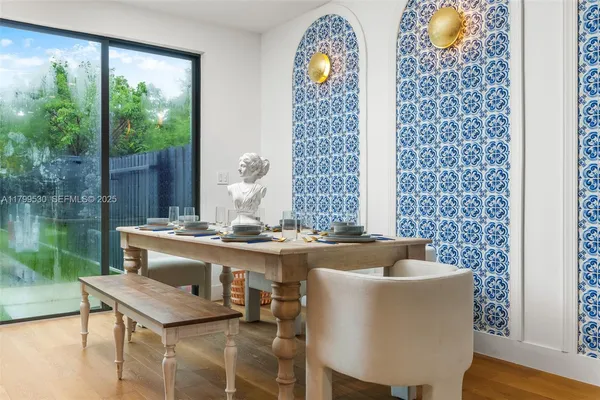 a dining room with furniture a chandelier and wooden floor