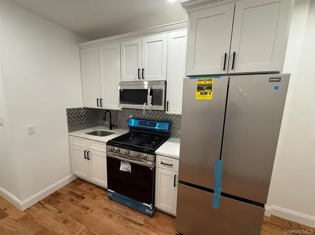 a kitchen with a stove microwave and refrigerator