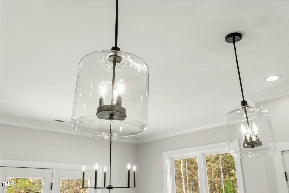 109 Averly Court Stem, NC 27581 - Photo 20 of 36 a room with a chandelier fan and glass door