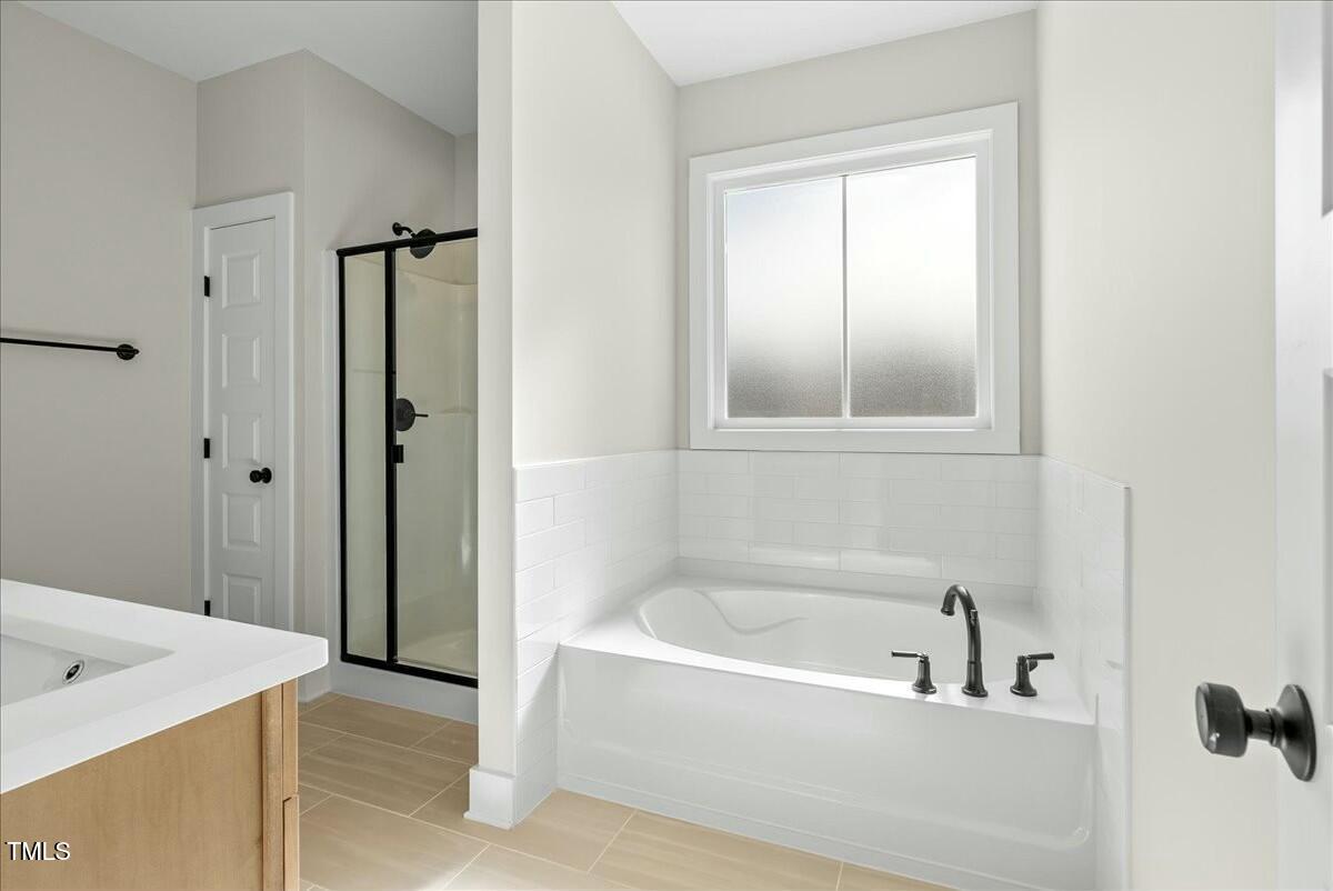 109 Averly Court Stem, NC 27581 - Photo 25 of 36 a white bath tub sitting next to a bathroom sink