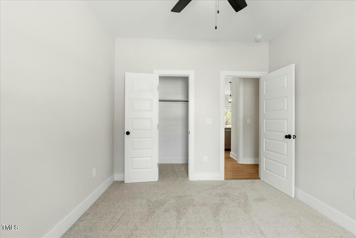 109 Averly Court Stem, NC 27581 - Photo 30 of 36 an empty room with closet and wooden door