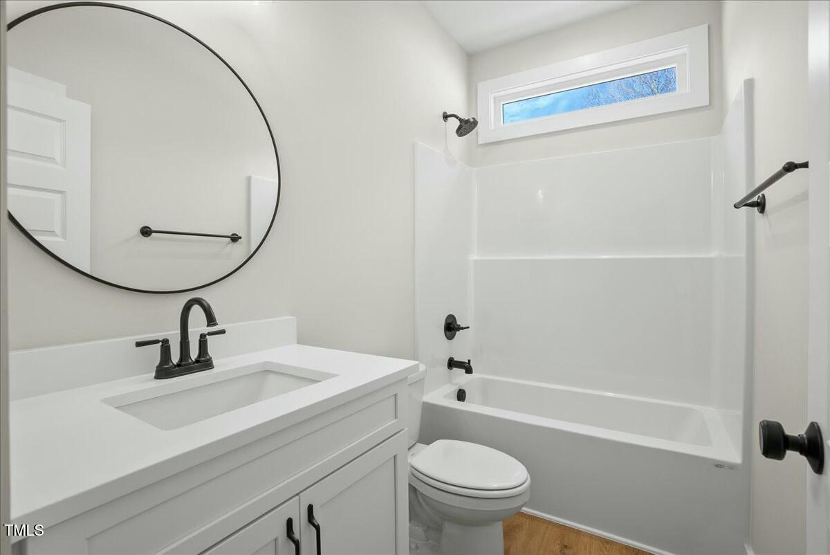 109 Averly Court Stem, NC 27581 - Photo 31 of 36 a bathroom with a sink a toilet and a mirror