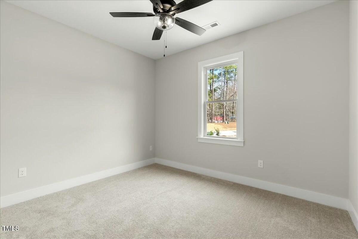 109 Averly Court Stem, NC 27581 - Photo 32 of 36 an empty room with a window and a fan