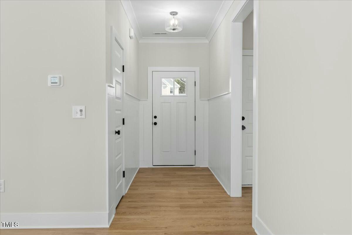 109 Averly Court Stem, NC 27581 - Photo 7 of 36 a view of a hallway with wooden floor and a bathroom