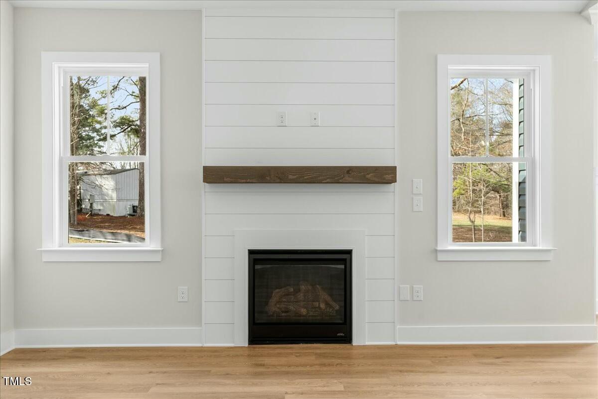 109 Averly Court Stem, NC 27581 - Photo 9 of 36 a living room with a fireplace and a window