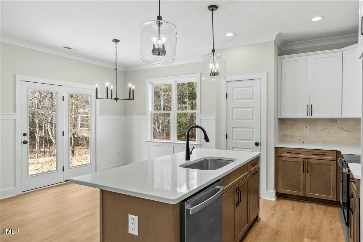 109 Averly Court Stem, NC 27581 - Photo 10 of 36 a kitchen with stainless steel appliances granite countertop a sink a stove and a refrigerator