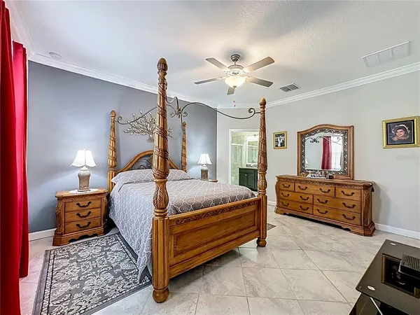 a bedroom with a bed and a chandelier