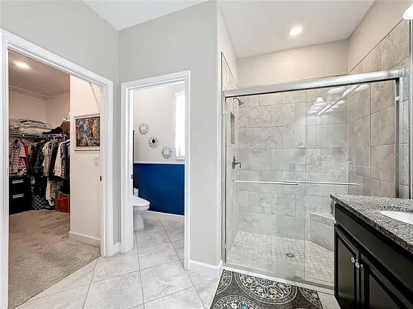 a view of walk in closet with clothes
