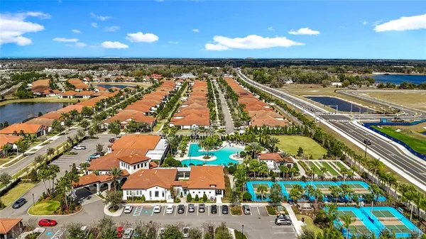 an aerial view of residential houses with outdoor space and swimming pool