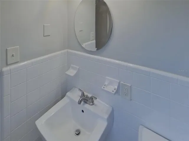 a bathroom with a sink and mirror