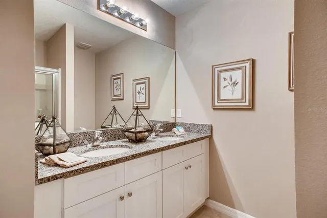 a bathroom with 2 sink and a mirror