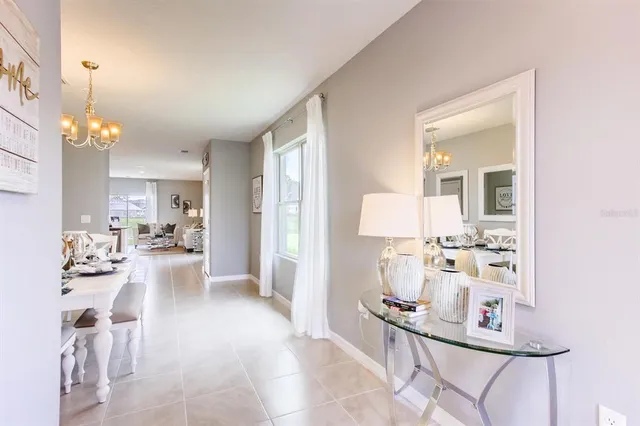 a view of a dining room with furniture and chandelier