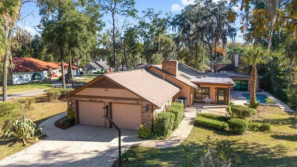 a view of a house with a yard patio and fire pit