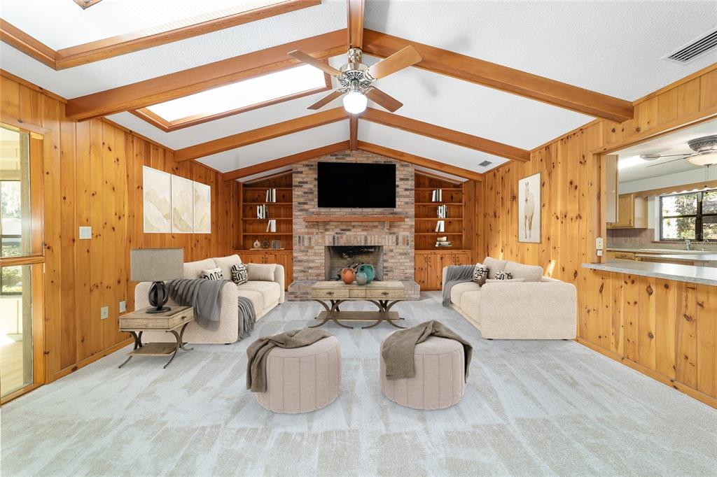 2416 Southeast 15th Street Ocala, FL 34471 - Photo 16 of 98 a living room with furniture a fireplace and a ceiling fan