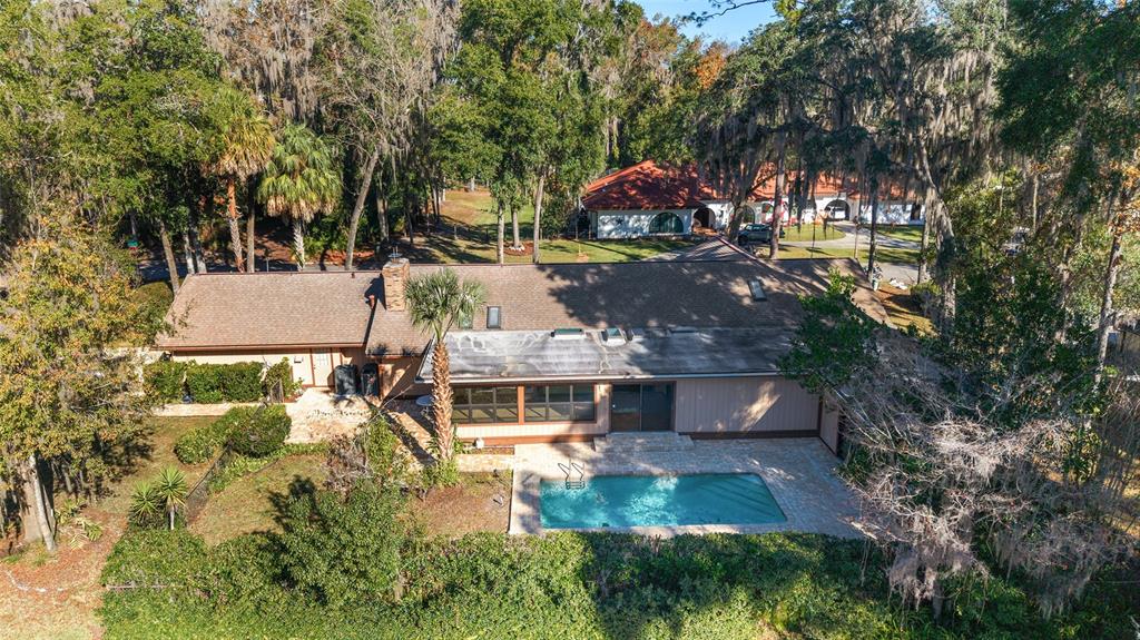 2416 Southeast 15th Street Ocala, FL 34471 - Photo 2 of 98 an aerial view of a house with swimming pool and large trees