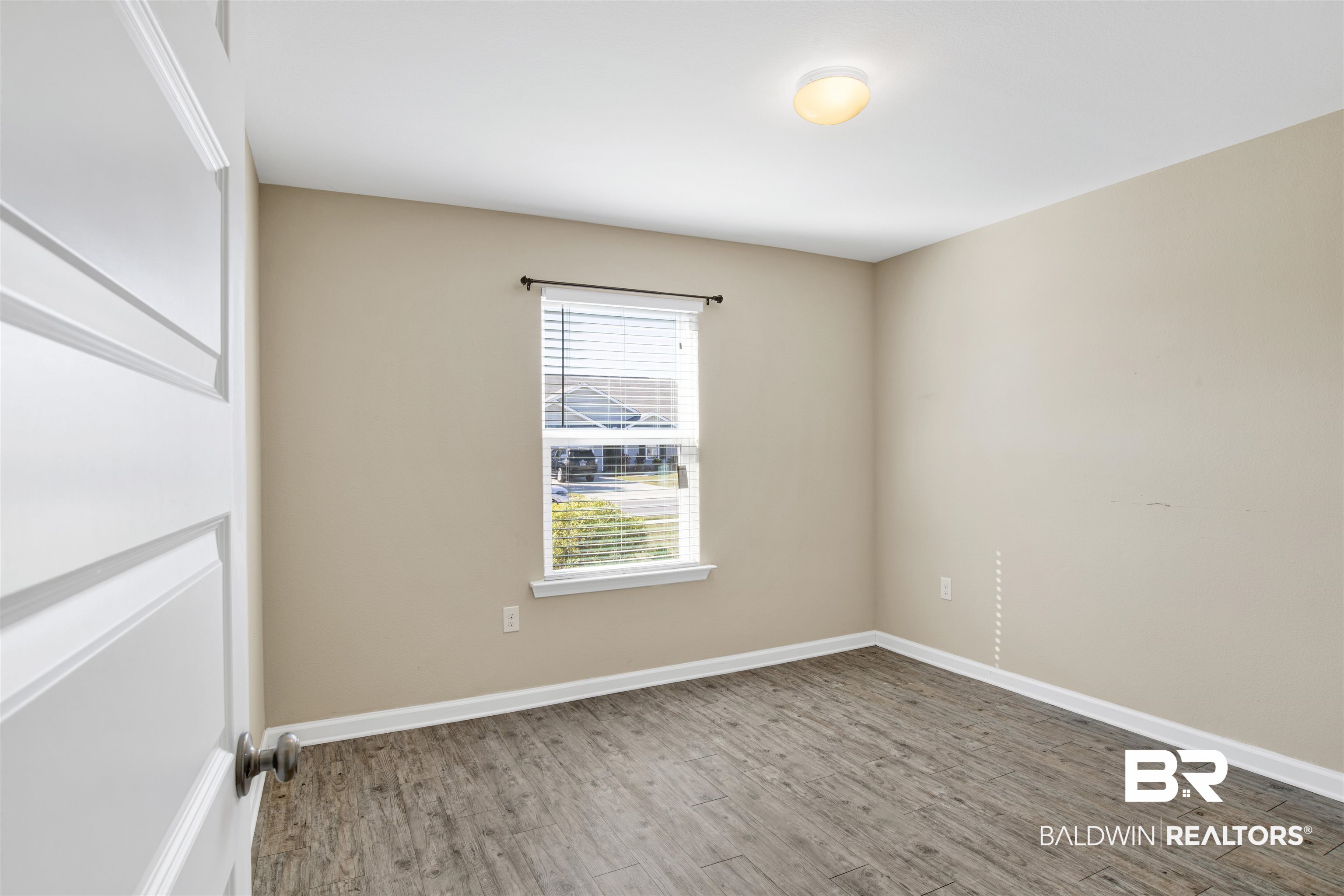 6926 Crimson Ridge Street Gulf Shores, AL 36542 - Photo 8 of 18 Empty room with wood finished floors and baseboards
