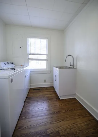 a room with a washer dryer and cabinets