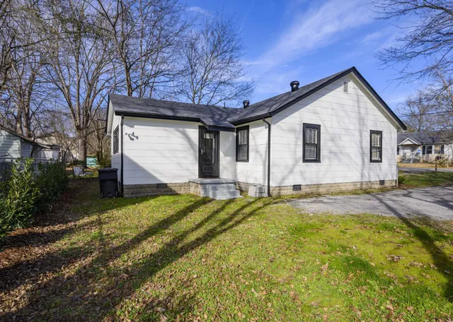 a backyard of a house with yard and garage