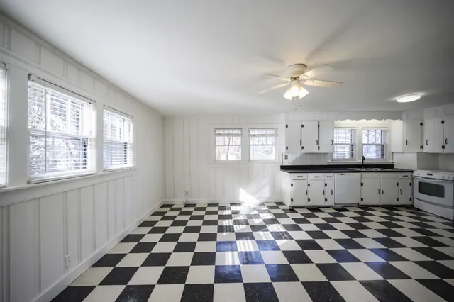 a kitchen with a checkered floor and a window