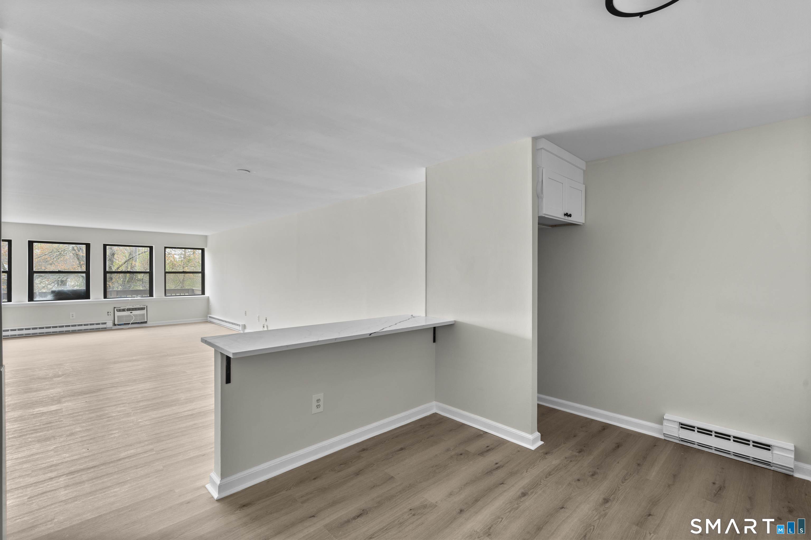 201 College Street, Unit 5 Middletown, CT 06457 - Photo 13 of 30 a view of an empty room with wooden floor and a window