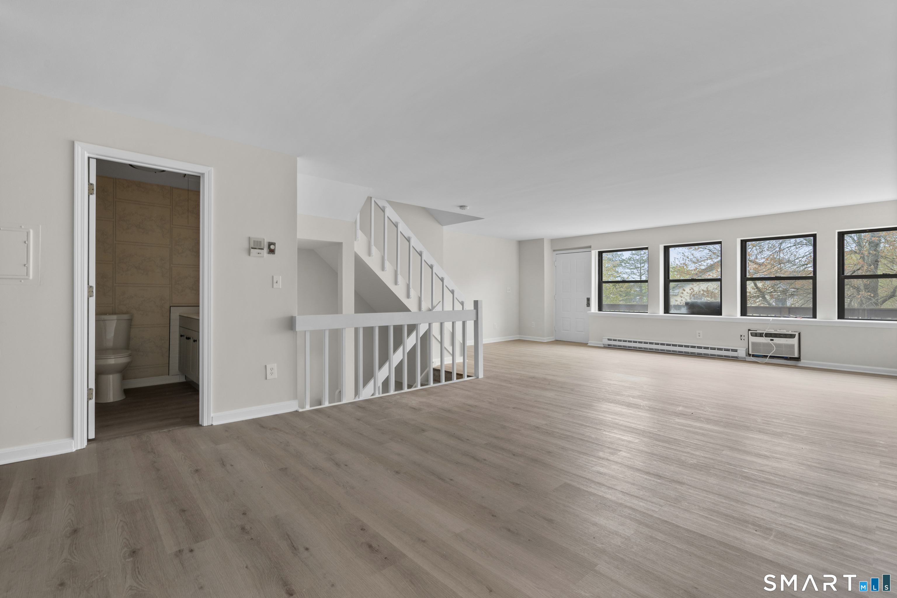 201 College Street, Unit 5 Middletown, CT 06457 - Photo 8 of 30 a view of an empty room with wooden floor and a window