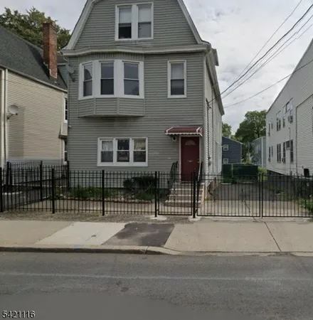 a view of a house with a iron gate