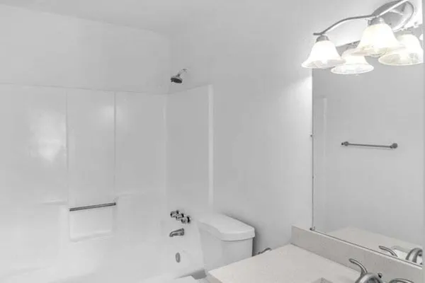 a bathroom with a toilet sink and shower