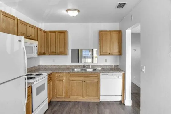 a kitchen with a white cabinets and white appliances