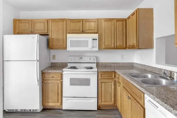 a kitchen with a sink stove and refrigerator