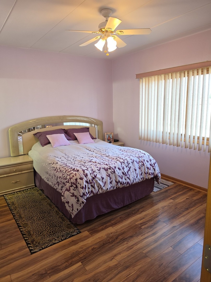 7902 Nagle Avenue, Unit 2S Burbank, IL 60459 - Photo 12 of 24 a bedroom with a bed and a chandelier