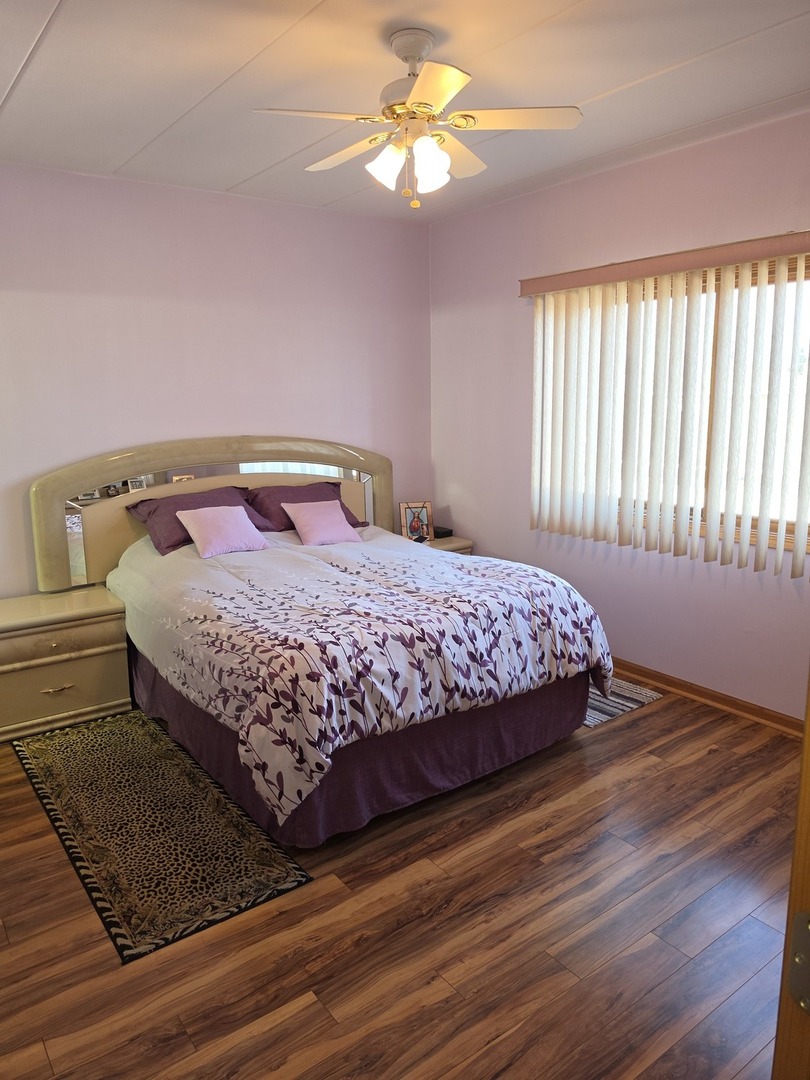 7902 Nagle Avenue, Unit 2S Burbank, IL 60459 - Photo 14 of 24 a bedroom with a bed and a window