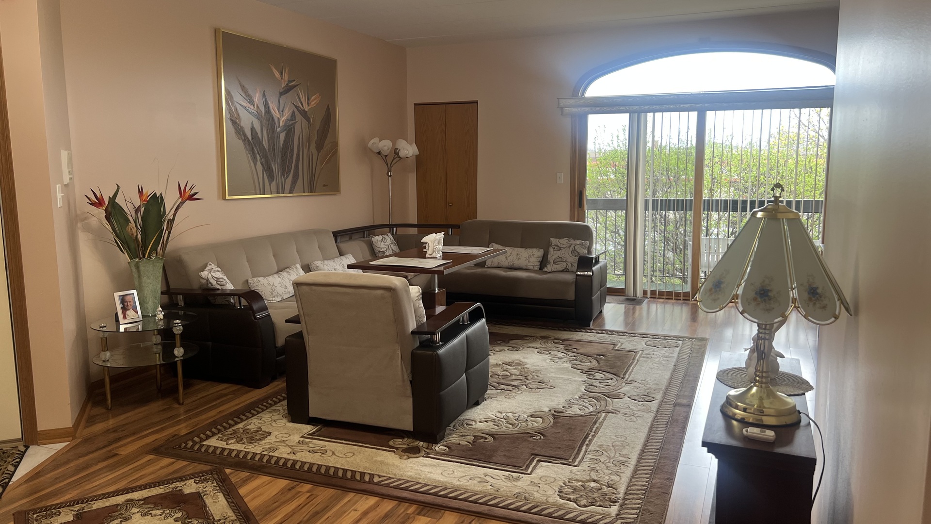 7902 Nagle Avenue, Unit 2S Burbank, IL 60459 - Photo 16 of 24 a living room with furniture and a floor to ceiling window