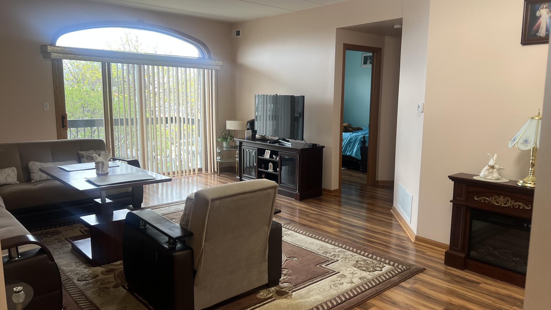 7902 Nagle Avenue, Unit 2S Burbank, IL 60459 - Photo 17 of 24 a living room with furniture and a flat screen tv