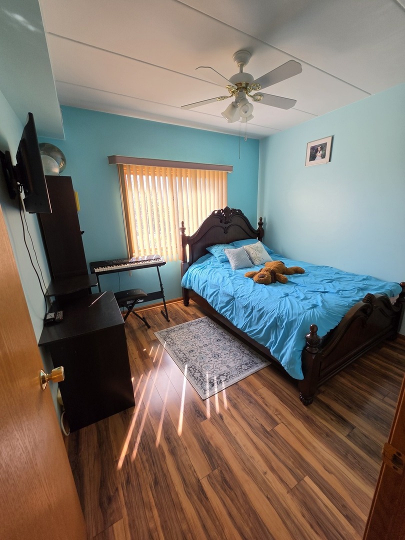 7902 Nagle Avenue, Unit 2S Burbank, IL 60459 - Photo 19 of 24 a bedroom with a bed and window
