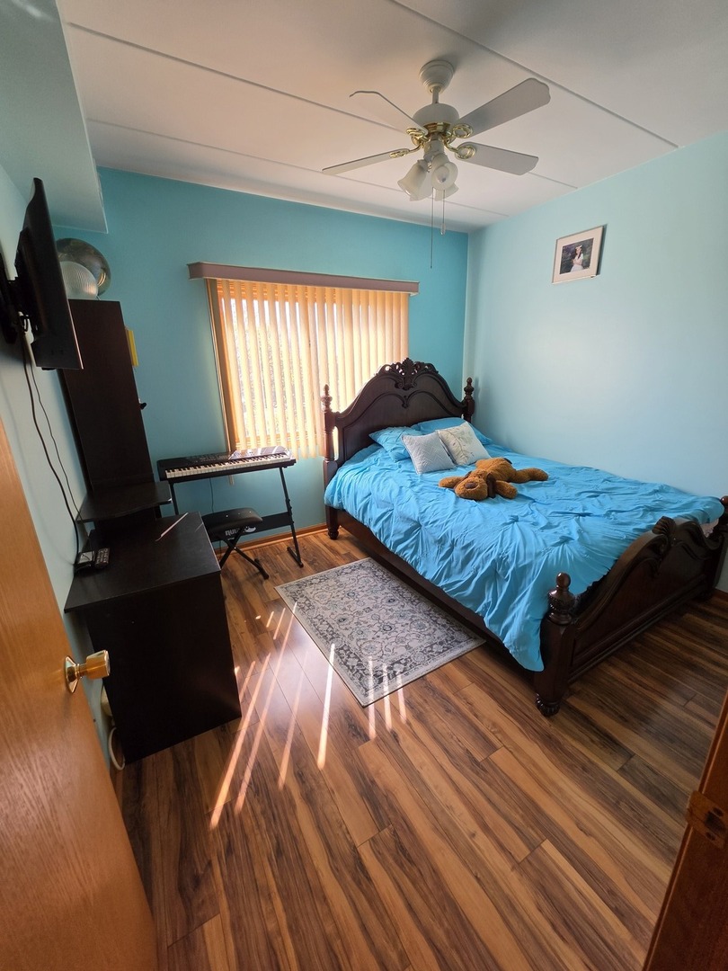 7902 Nagle Avenue, Unit 2S Burbank, IL 60459 - Photo 20 of 24 a bedroom with a bed and window